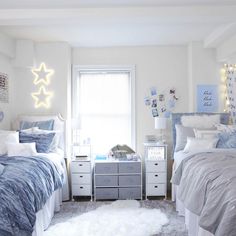 a bedroom with two twin beds and a white rug in front of the bed is an illuminated window