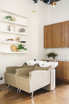 a living room filled with furniture and lots of shelves