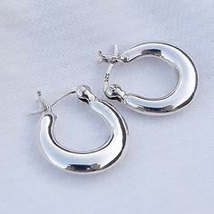 Real 925 Sterling Silver Thick Chunky Hoop Earrings These lovely hoop earrings can be used in Earlobes and second ear holes. Opening Diameter Measures 7mm INSIDE Full Length from Ear Wire Measures 12mm OUTSIDE Full Length from Ear Wire Measures 15mm THICKEST Part Measures 5mm Sold by Pair Jewelry will come in a gift box * Please read shop policy before placing an order * *JEWELRY CARE* Sterling Silver will tarnish over time, but to help keep your jewelry looking beautiful - Clean with a soft dry Chunky Huggie Earrings Silver, Silver Earrings Hoops Small, Thick Silver Hoops, Thick Silver Hoop Earrings, Silver Earrings Hoop, Small Hoop White Gold Earrings, Small Hoop Sterling Silver Earrings For Pierced Ears, Silver Small Hoop Huggie Earrings, Silver Round Huggie Earrings With Polished Finish