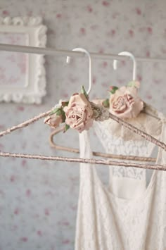 some clothes hangers with pink flowers on them