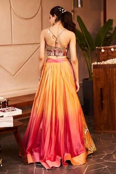 Pink and peach ombre lehenga with sequins, beads, cutdana, nakshi and tassels embroidered desert and camel motifs. Paired with coordinating thread and lace embroidered bustier. - Aza Fashions Orange Embroidered Lehenga For Party, Orange Embroidered Party Lehenga, Party Embroidered Orange Lehenga, Orange Embroidered Dress For Reception, Bohemian Orange Choli For Wedding, Orange Dori Work Dress For Wedding, Peach Embroidered Lehenga, Orange Dress With Dori Work For Wedding, Orange Wedding Dress With Dori Work