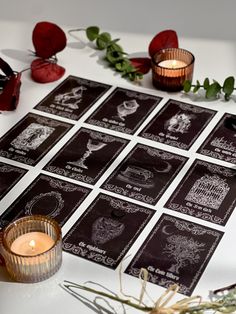 a table topped with lots of cards and candles