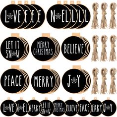 black and gold christmas ornames with white writing on them, hanging from clothes pins