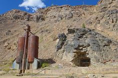 there is a rock outcropping next to a building in the mountain side