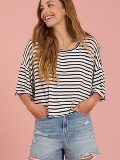 This relaxed tee offers effortless style. The boxy silhouette with dolman sleeves and rolled cuffs add a touch of casual charm. The classic stripes make it a versatile choice, perfect for layering or wearing on its own. Chic Striped Crew Neck T-shirt, Chic Short Sleeve Tops With Striped Sleeves, Chic Striped T-shirt For Summer, Chic Tops With Striped Sleeves For Day Out, Chic Oversized Top With Rolled Sleeves, Trendy Horizontal Stripe T-shirt For Spring, Trendy T-shirt With Horizontal Stripe For Spring, Chic White Horizontal Stripe Top, Chic White Tops With Horizontal Stripes