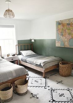 a bedroom with two twin beds and baskets on the floor