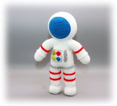 a crocheted white and blue spaceman doll