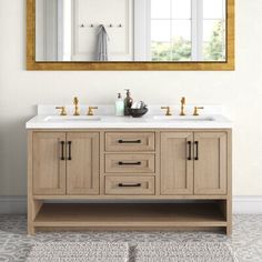 a bathroom vanity with two sinks under a large mirror