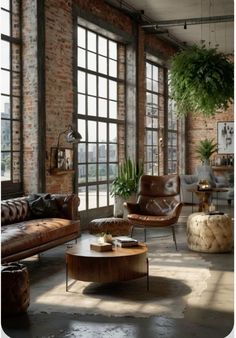 an industrial living room with brick walls and large windows, leather couches and coffee table