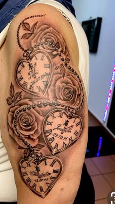 a woman's arm with a clock and roses tattoo on it