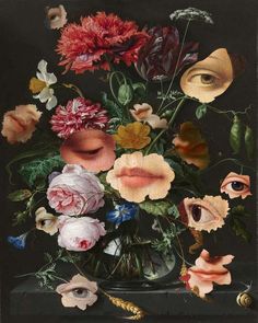 a vase filled with lots of flowers on top of a black table next to an eye