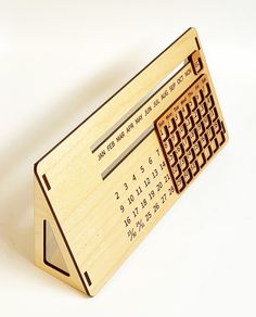 a wooden business card holder with a mechanical keyboard on it's front and back sides