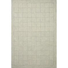 a white rug with squares and lines on the floor in front of a white background