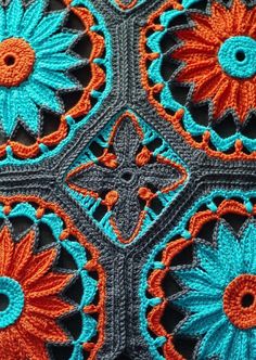 an orange and blue crochet pattern with flowers on it