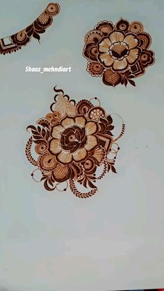 two henna designs on the side of a wall