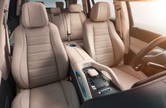 the interior of a car with beige leather seats