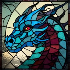 a stained glass window with a blue dragon on it's head and red eyes