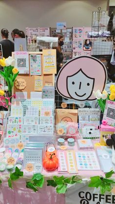 there is a table with many items on it that include cards, stickers and flowers