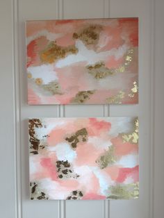 two pink and gold paintings hanging on the wall next to each other in front of a white door