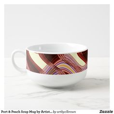 a white bowl sitting on top of a counter next to a marble countertop with an abstract design