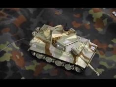 a toy army tank is laying on the ground