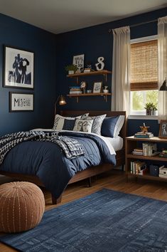 a bedroom with dark blue walls and wooden flooring is pictured in this image, there are bookshelves on either side of the bed