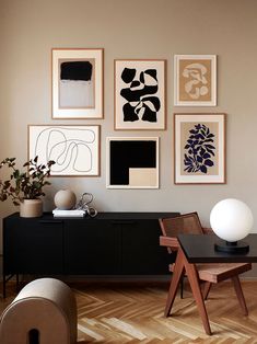 a living room filled with furniture and pictures on the wall