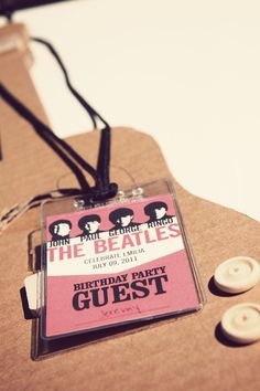 the beatles badge is attached to a piece of cardboard with buttons and string on it