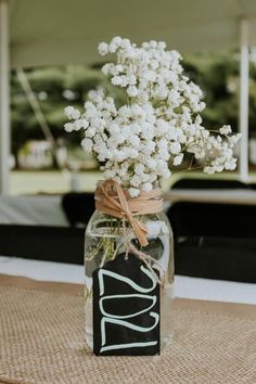 a mason jar filled with baby's breath flowers