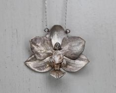 The Orchid Necklace, cast from a real orchid flower with a herkimer diamond set in between it's delicate petals.  Available in sterling silver and gold plate silver. Orchid Necklace Silver, Petal Jewellery, Virgo Aura, Orchid Ring, Orchid Necklace, Orchid Jewelry, Anahata Chakra, Geode Necklace, The Orchid