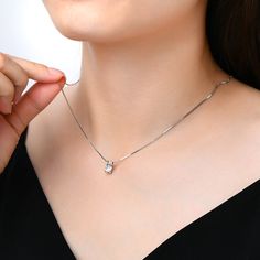 This stunning jewelry necklace for women features a brilliant moissanite diamond pendant that dazzles with every movement. Perfect as a statement piece or for everyday elegance, our moissanite necklace offers a touch of luxury. Discover the beauty of moissanite necklaces designed to captivate and inspire. ✧ Carat Weight: 1Ct ✧ Stone Dimension: 6.5mm ✧ Necklace Length: 18" ✧ Stone Shape: Round ✧ Enhancement: Lab Created ✧ Stone Color: Diamond White ✧ Stone Clarity: VVS1 ✧ Stone Grade: E ✧ Stone C Diamond White Moissanite Pendant Necklace, Moissanite Solitaire Necklace With Round Pendant, Moissanite Diamond Cut Necklaces, Silver Moissanite Minimalist Necklace, Lab Grown Diamond Necklace With Single Diamond, Minimalist Silver Moissanite Necklace, Silver Minimalist Moissanite Diamond Necklace, Minimalist Silver Moissanite Diamond Necklace, Moissanite Solitaire Pendant Necklace With Diamond Accents