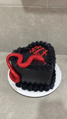 a black and red cake on a white plate