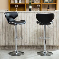 two black barstools in front of a bar