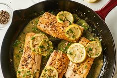 salmon with lemons and herbs in a skillet