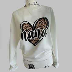 Nana Leopard Print Heart Sweatshirt Cream Womens Large New Cream Colored Sweatshirt With A Leopard Print Heart Screen Print On Front, With “Nana” Measures Approximately 23” Ptp, 27” Long Brand New In Manufacturer Packaging, No Tags Attached Smoke Free Home White Relaxed Fit Tops With Heart Print, White Heart Print Top With Relaxed Fit, Casual Tops With Name Print, Crew Neck Tops With Name Print, Colorful Sweatshirt, Heart Sweatshirt, Screen Print, Cream Color, New Color