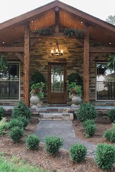 the front entrance to a home with potted plants