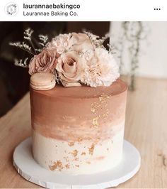 a close up of a cake on a plate with flowers and macaroni shells