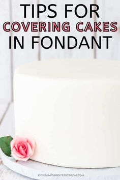 a white cake with pink flowers on top and the words tips for covering cakes in fondant