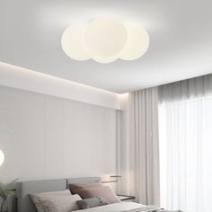 a bedroom with a bed and two lamps on the ceiling