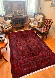 a living room filled with furniture and a red rug