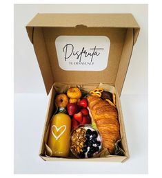 an open box filled with assorted fruits and pastries