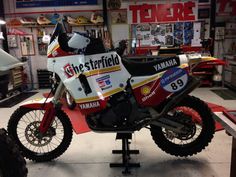 a white and red dirt bike on display in a shop