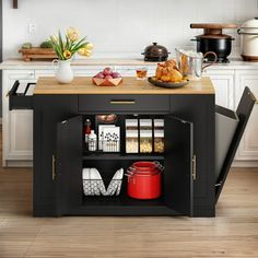 a kitchen island with an open door on the side and food in containers on top