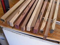 several pieces of wood sitting on top of a refrigerator