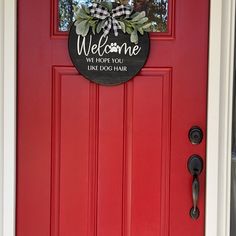 a red door with a welcome sign on it