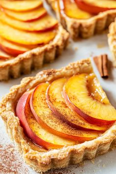 sliced peaches and cinnamon on top of a tart crust