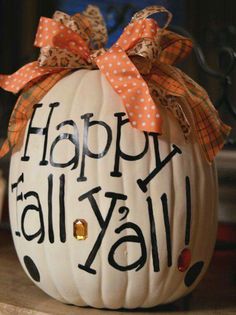 a white pumpkin with the words happy fall y'all painted on it