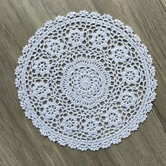 a white doily sitting on top of a wooden table