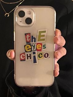 someone is holding up their cell phone case with the words chicago on it in different colors