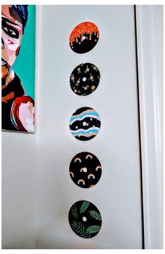 the wall is decorated with different types of buttons on it, and there are paintings above them